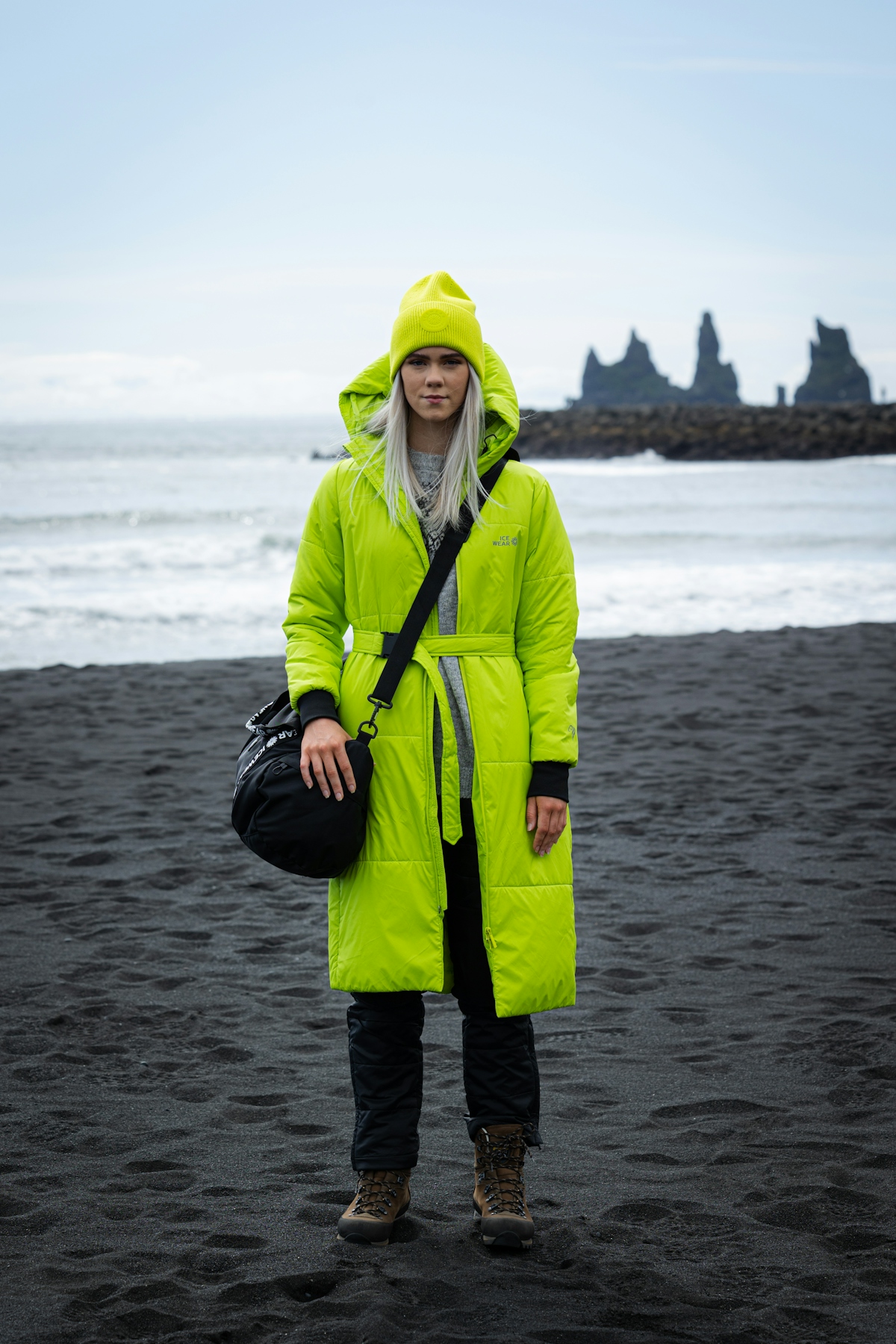 woman-green-jacket-hat-bag-blackbeach.jpeg