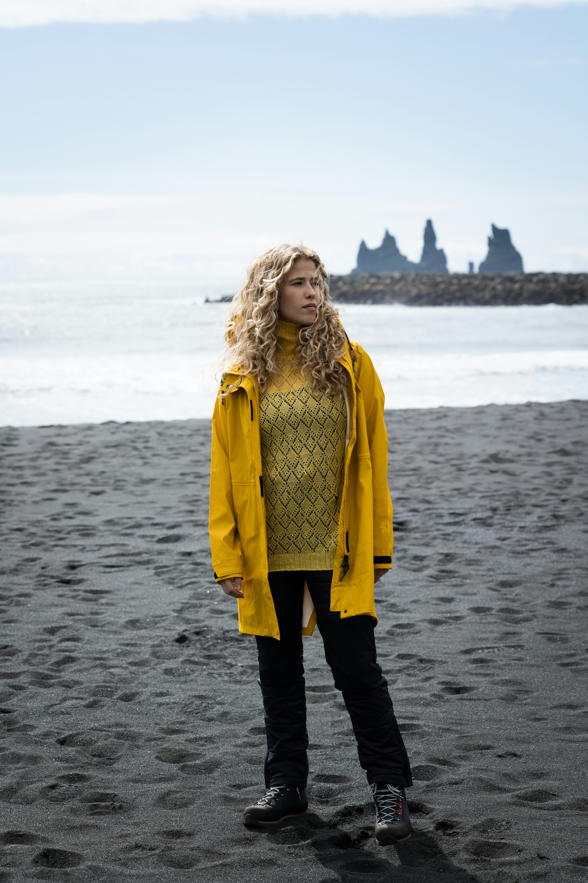 woman-yellow-rainjacket-sweater-blackbeach.jpeg