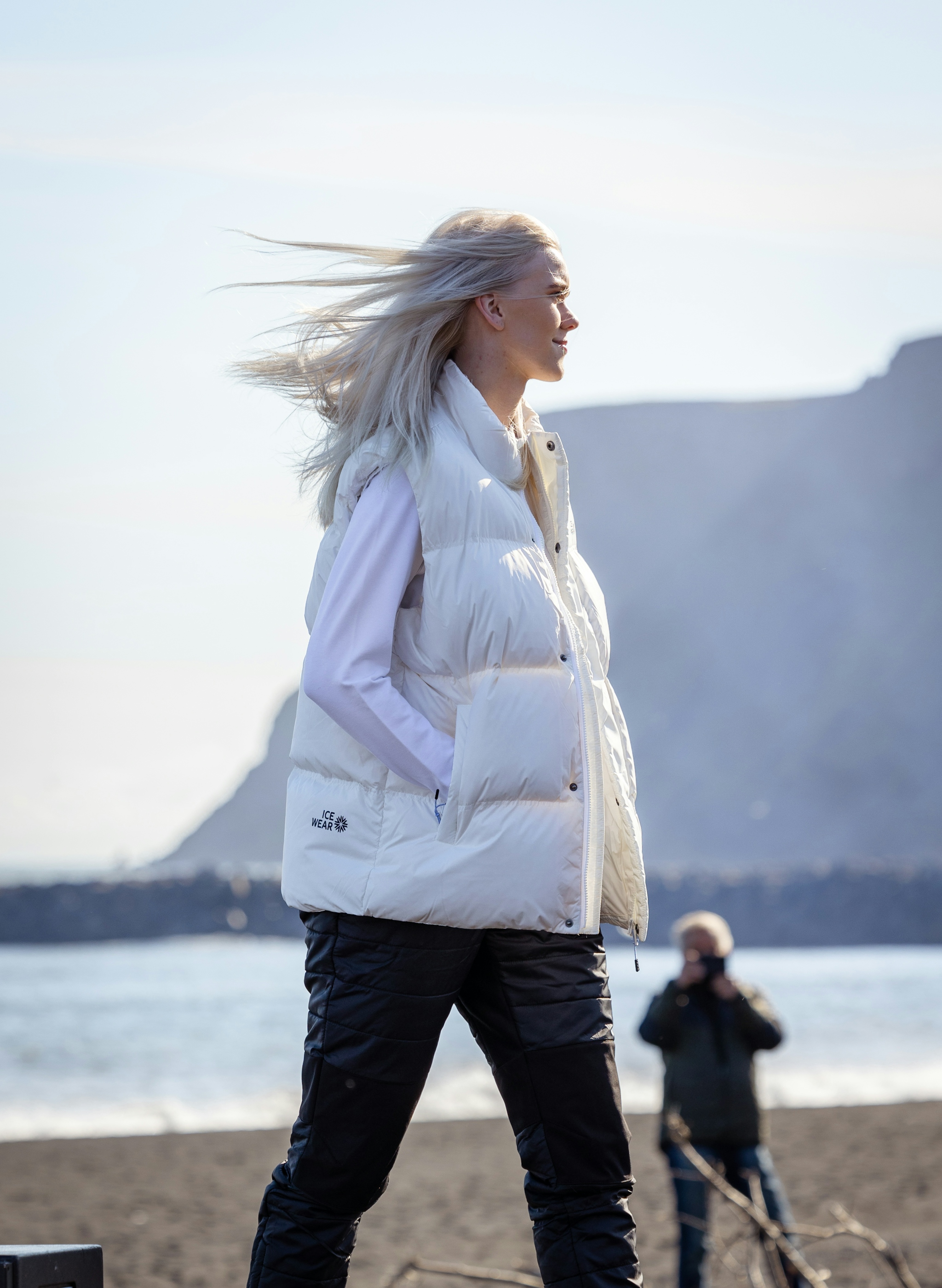 woman-white-downvest-blackbeach.jpeg