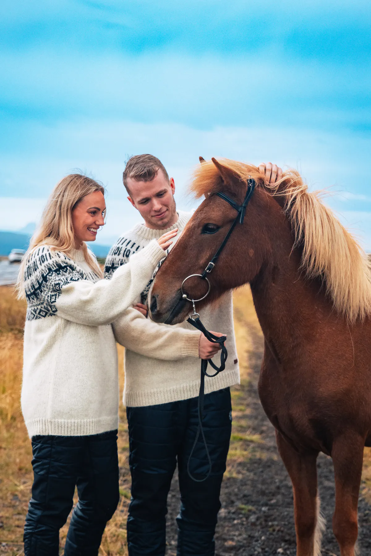 couple petting a horse