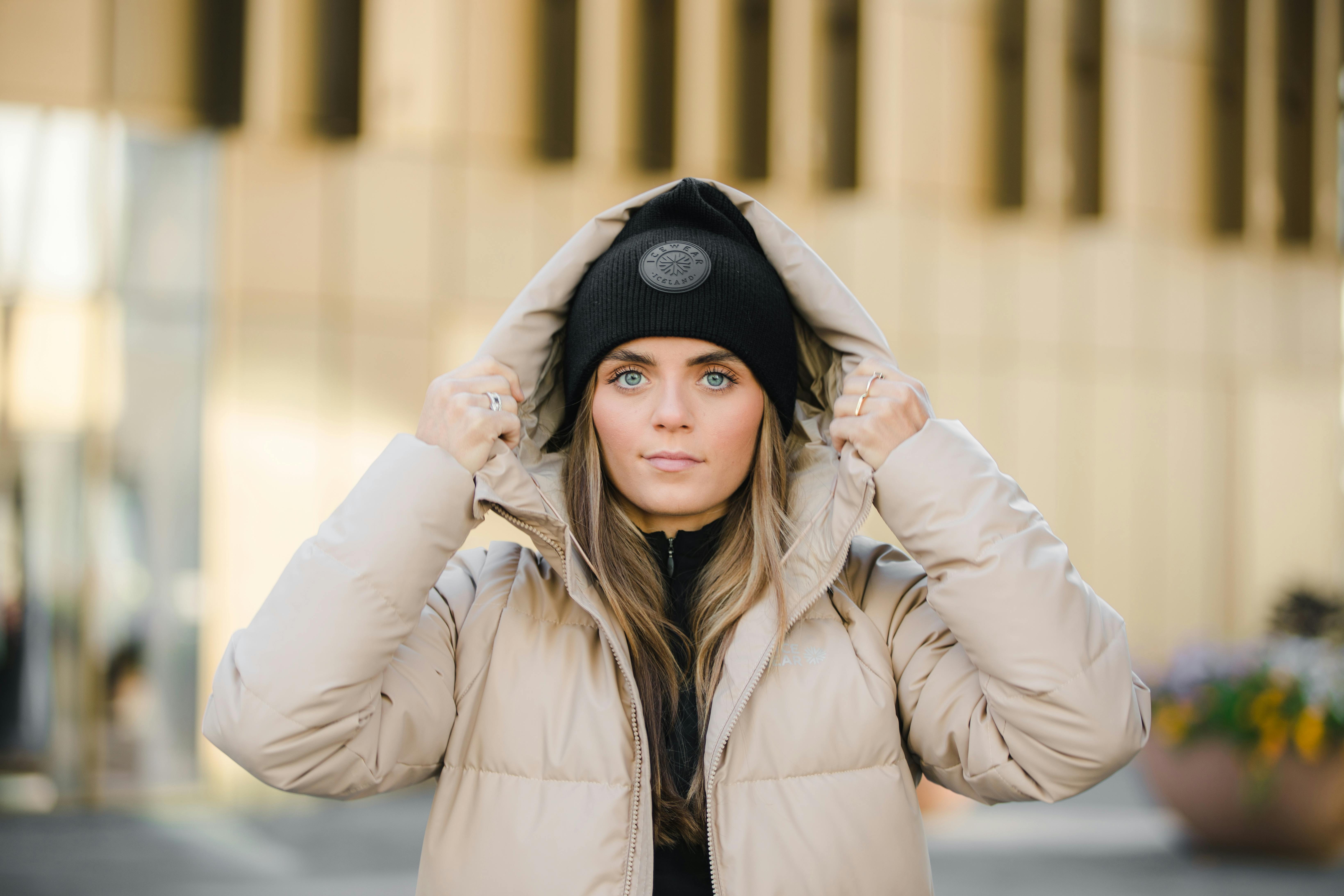 woman wearing winter jacket and a hat in Reykjavík city center