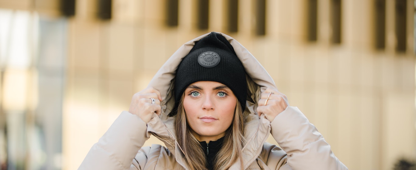 woman wearing winter jacket and a hat in Reykjavík city center