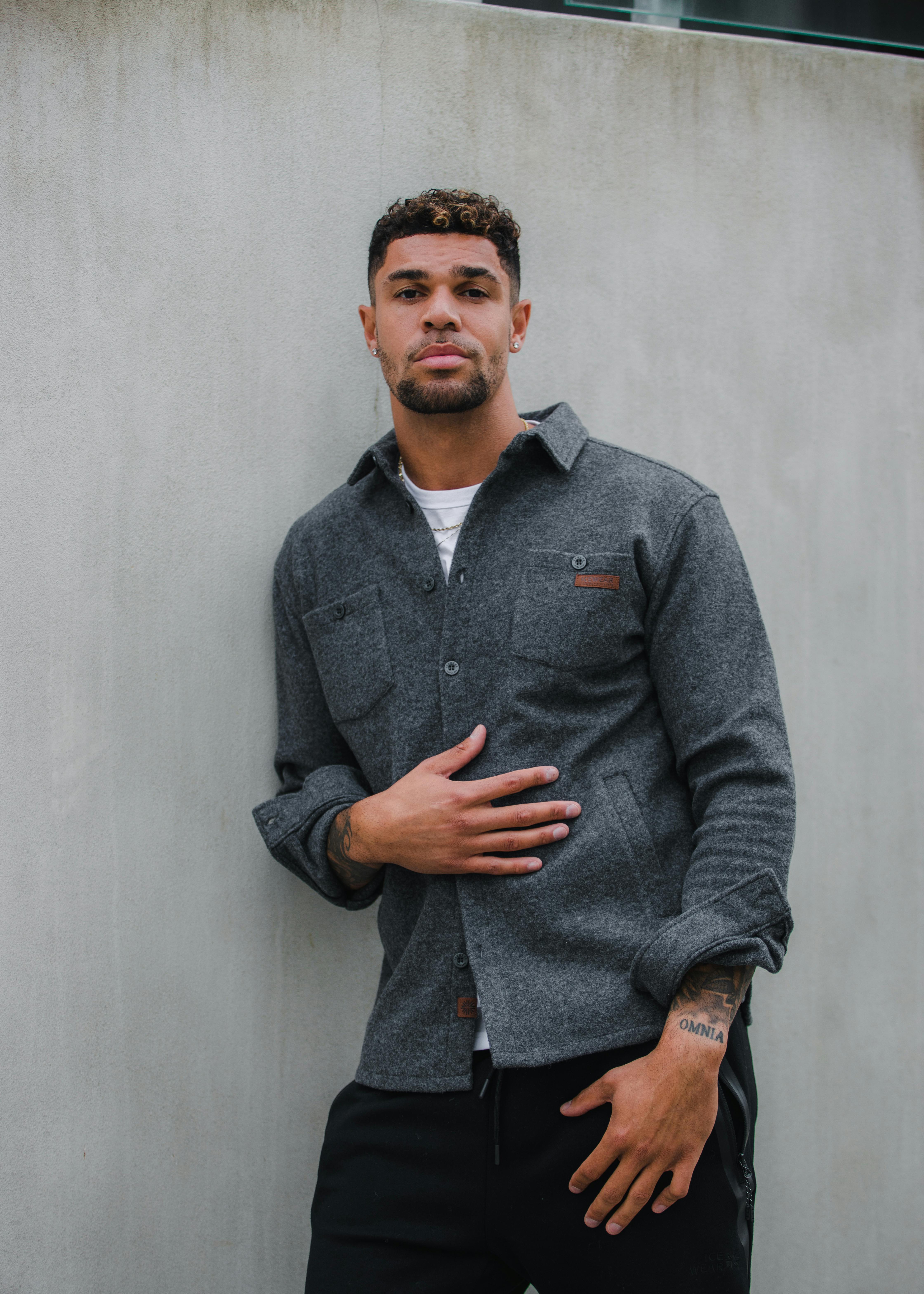 man standing next to wall in Reykjavík city center