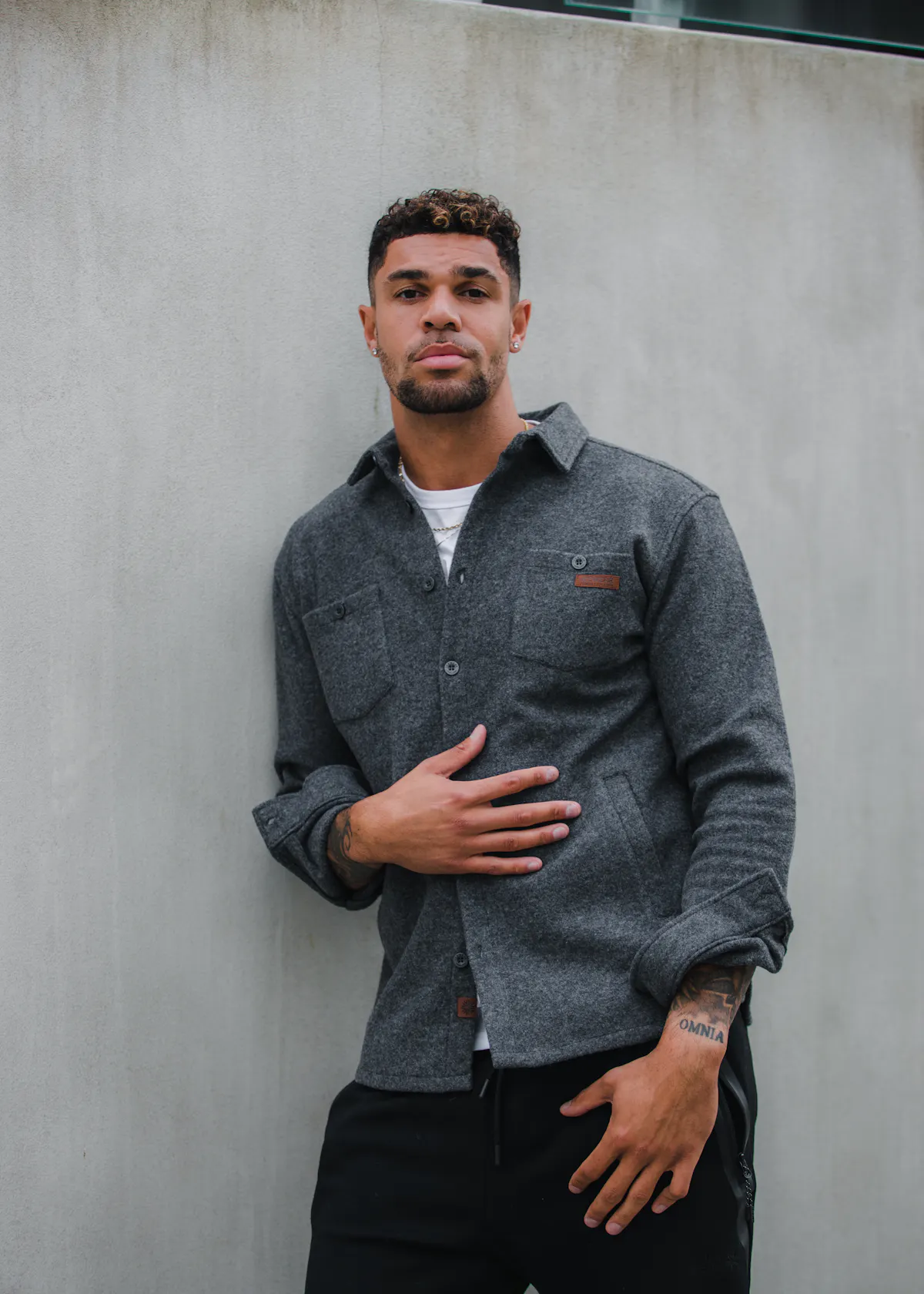 man standing next to wall in Reykjavík city center