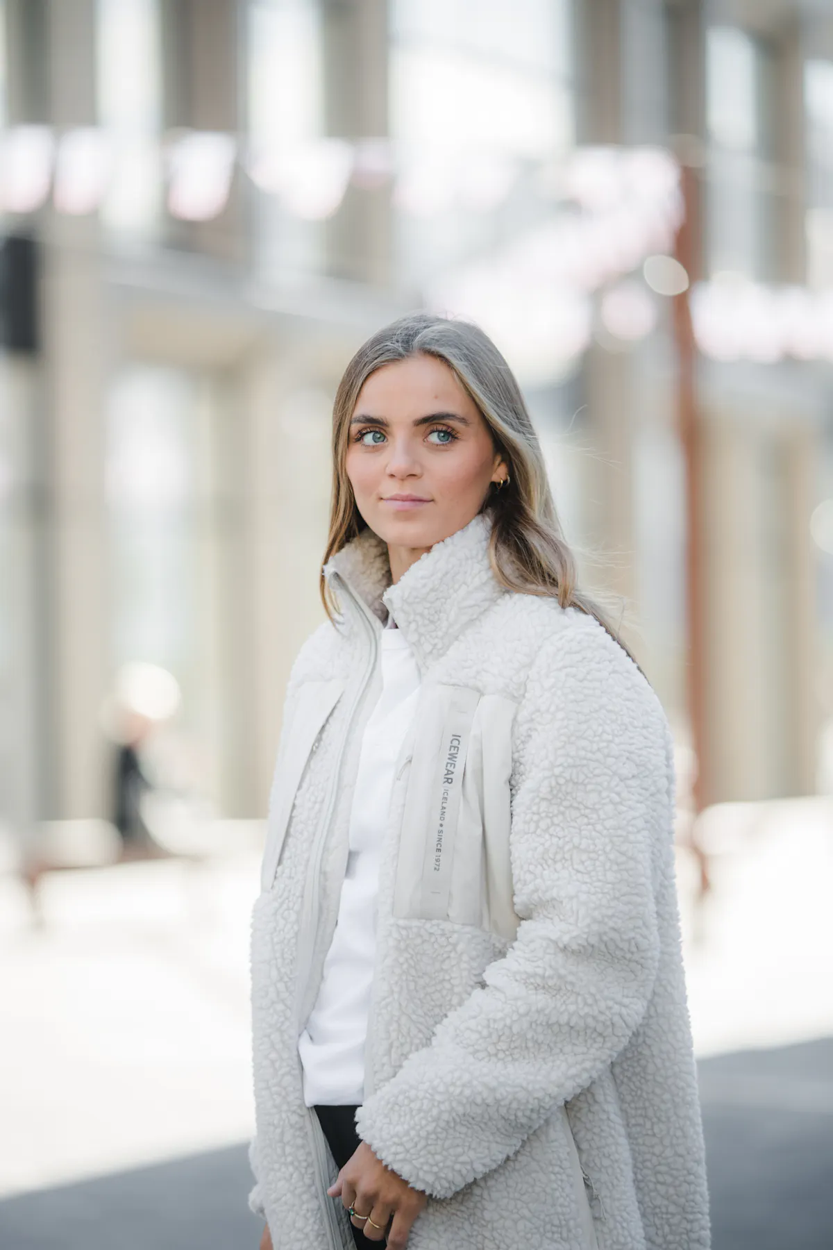 woman wearing long fleece coat in city center Reykjavík