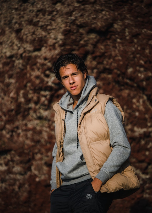 man in a hoodie and vest