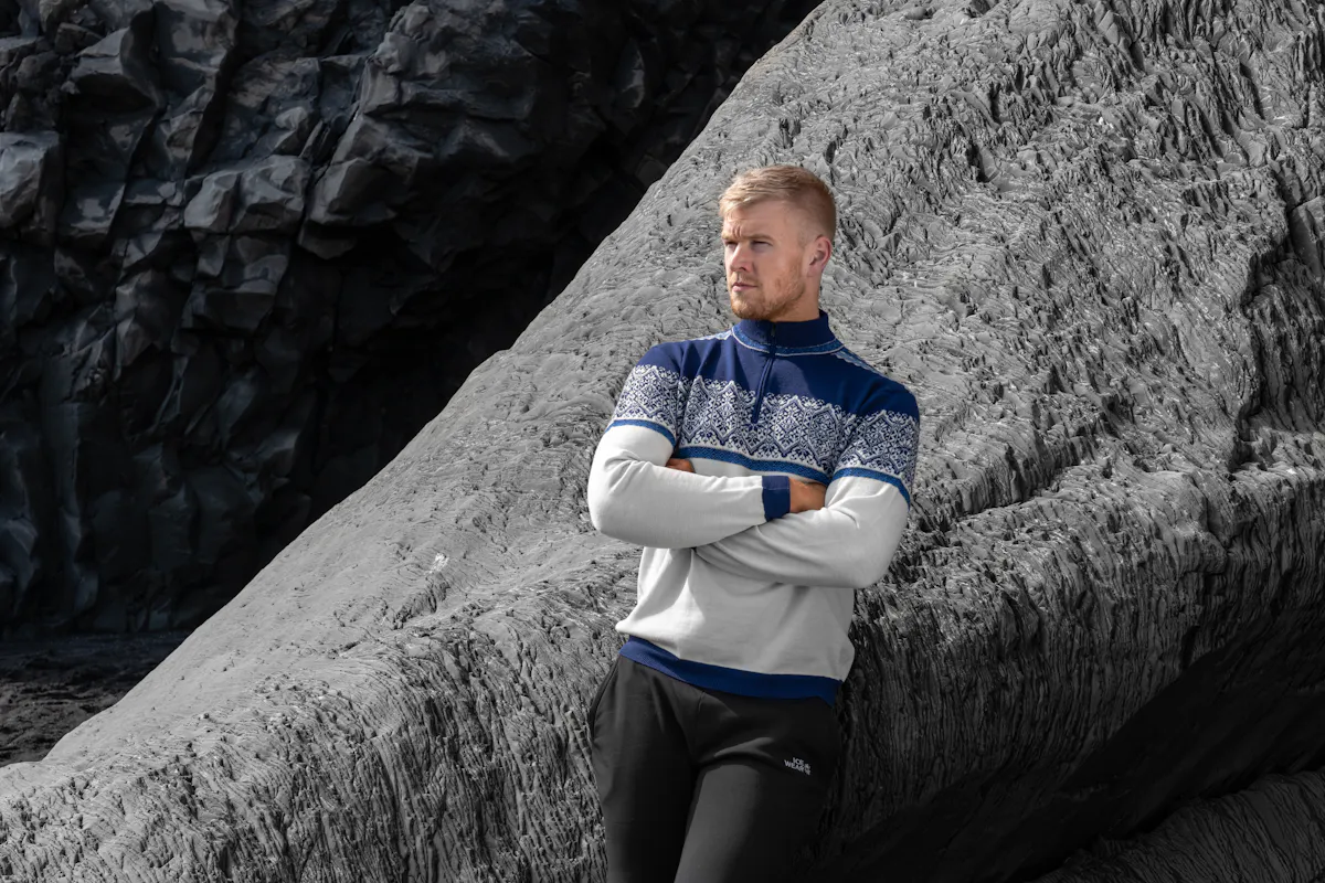 man standing next to cliff