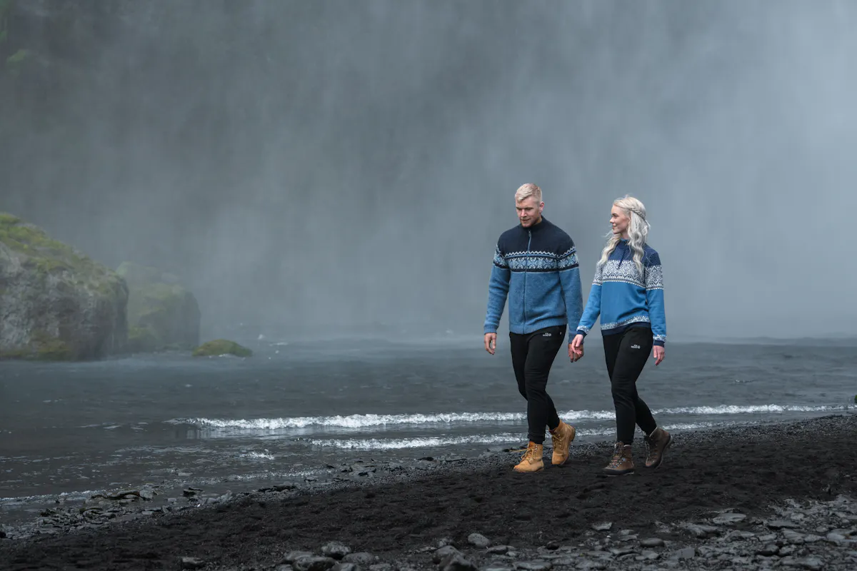 couple walking close to waterfall