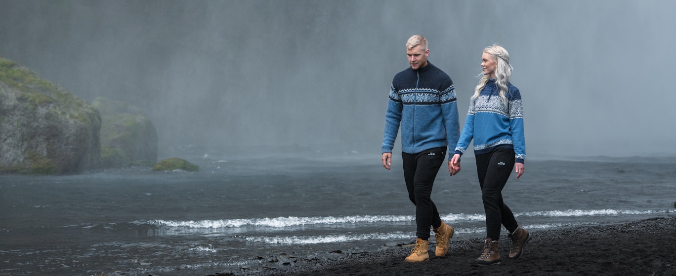 couple walking close to waterfall