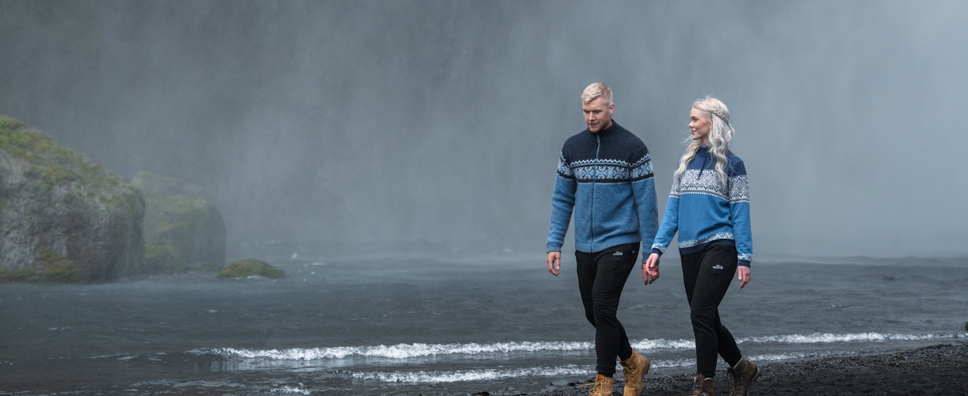 couple walking close to waterfall