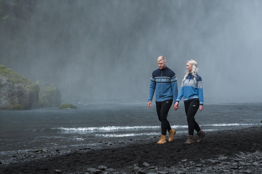 couple walking close to waterfall
