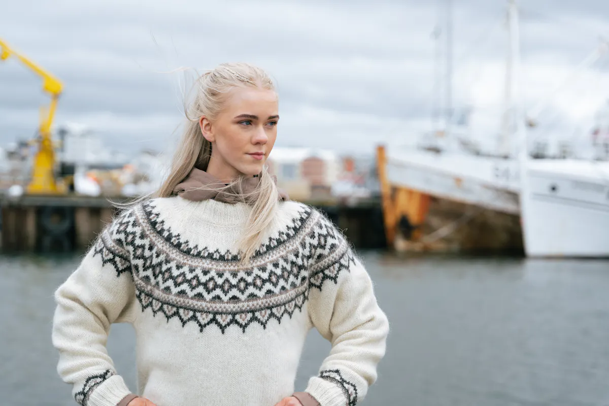 woman wearing Icelandic wool sweater at the harbor