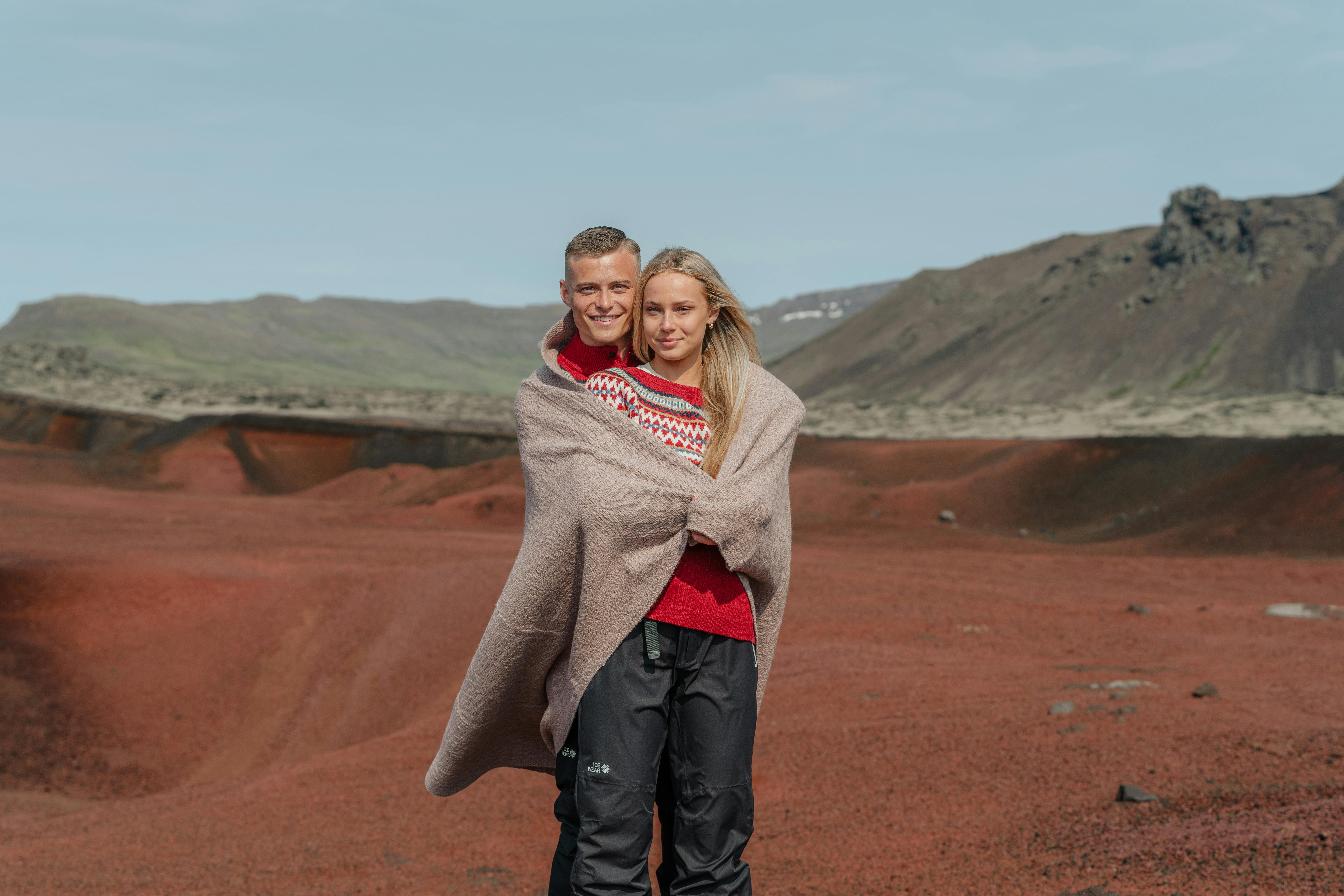 A couple with a blanket around them.