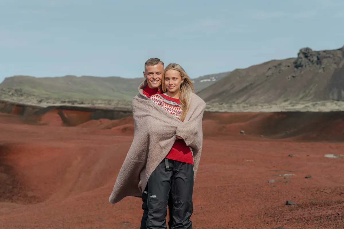 A couple with a blanket around them.