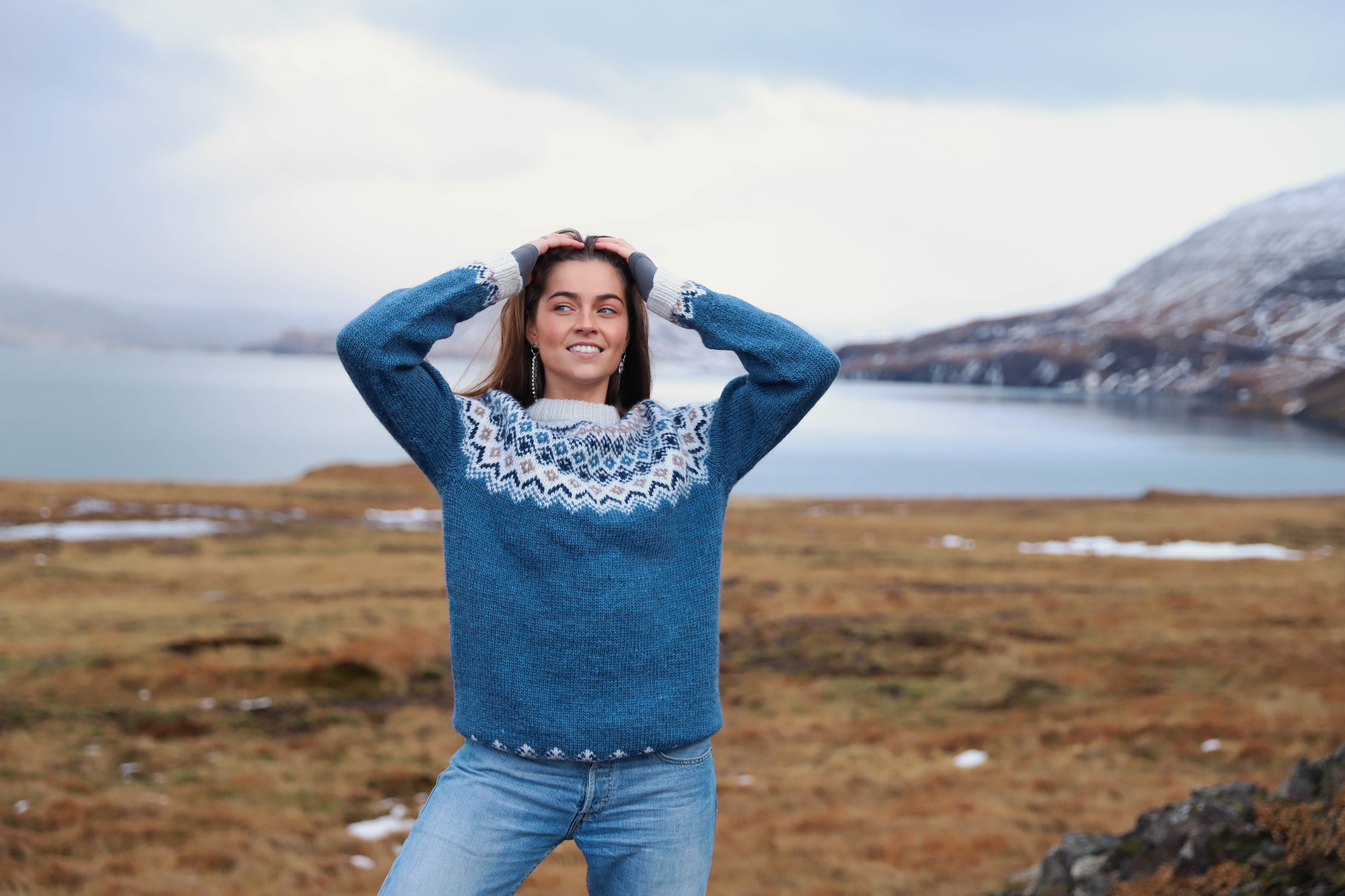 woman wearing a Icelandic wool sweater  by the water