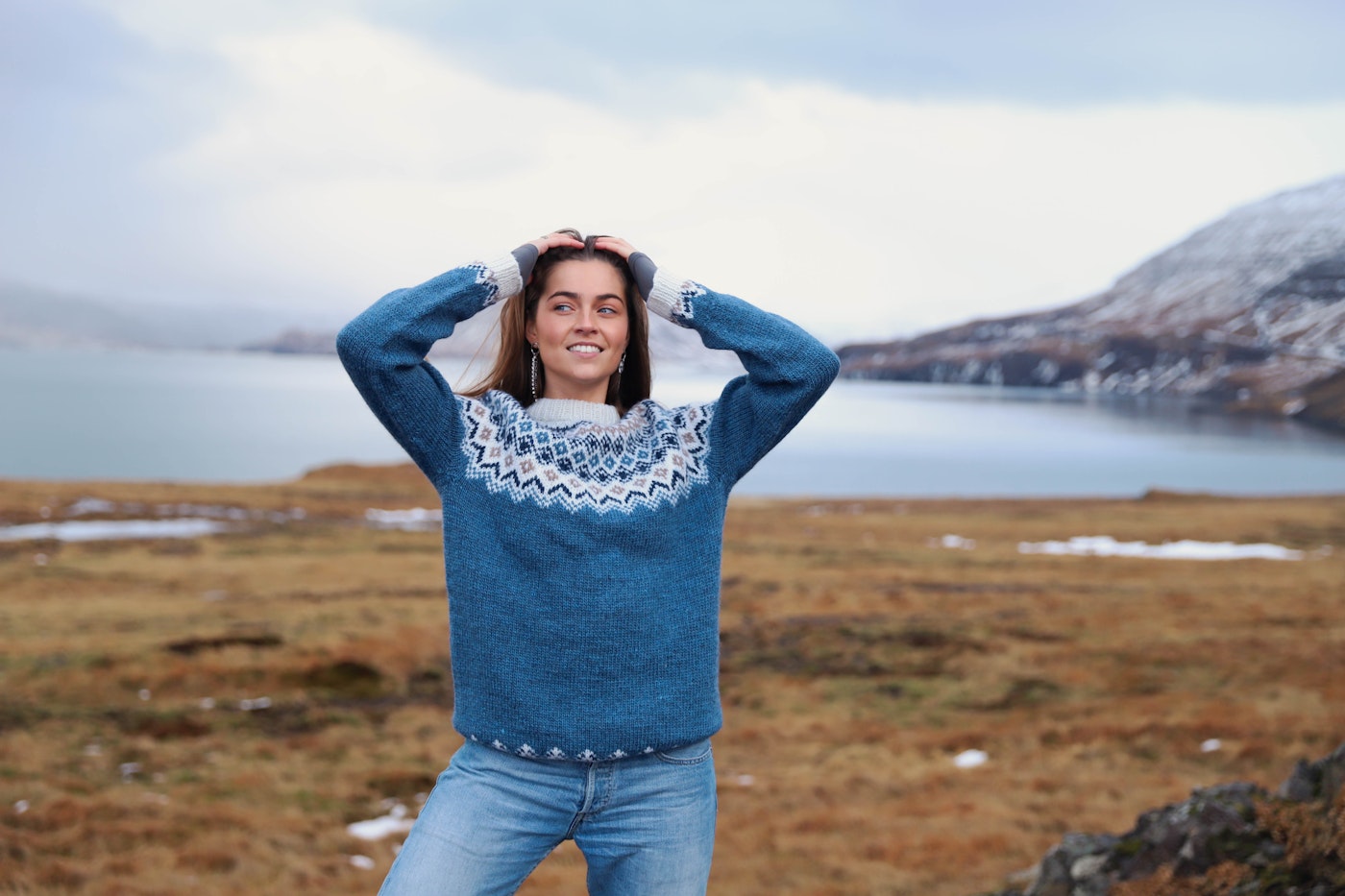 woman wearing a Icelandic wool sweater  by the water