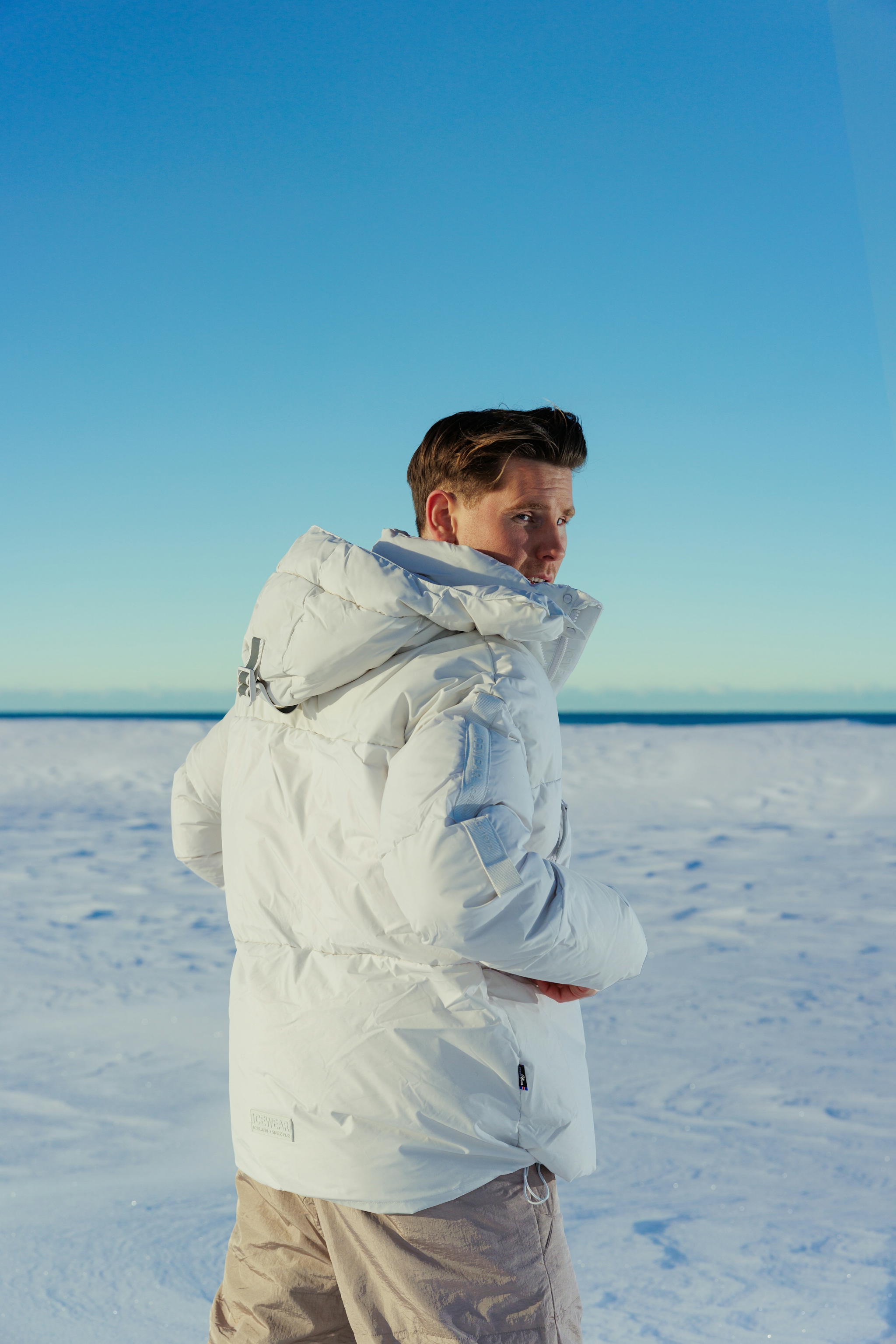 man-in-white-puffer-jacket-and-base-snowpants-9.jpeg