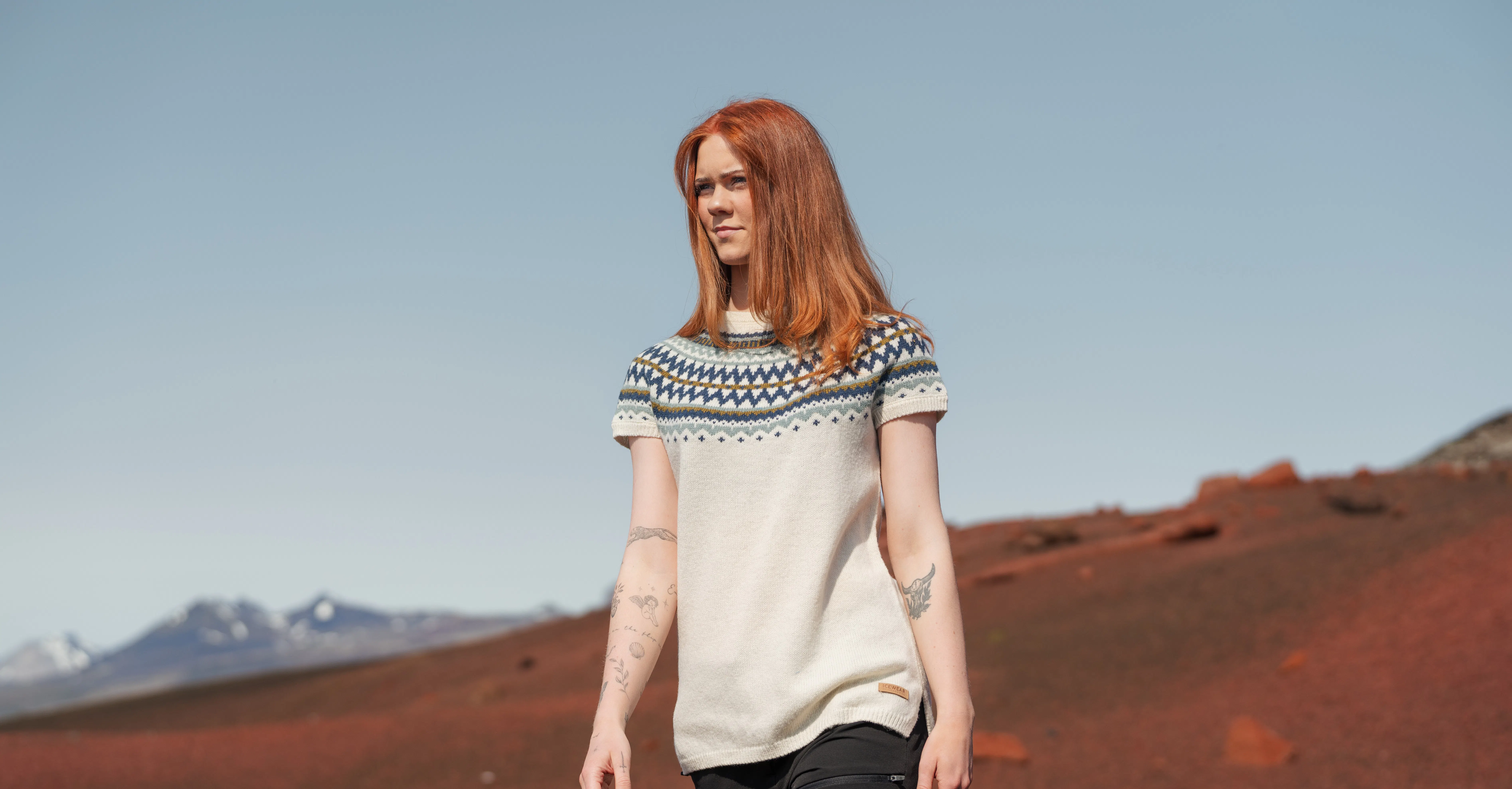 woman wearing sweater vest in a warm summer day in Icelandi